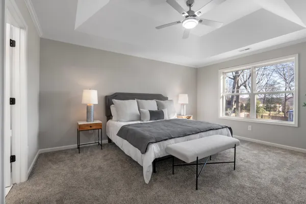 a bedroom with a bed and a chandelier