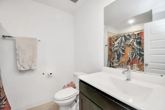 a bathroom with a sink toilet and shower