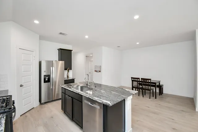 a kitchen with a table and chairs in it
