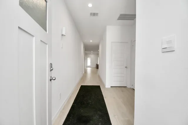 a view of a hallway with white walls