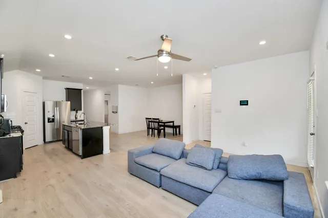 a living room with furniture and a chandelier