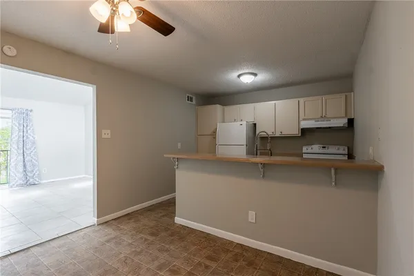 a kitchen with stainless steel appliances a refrigerator sink and cabinets