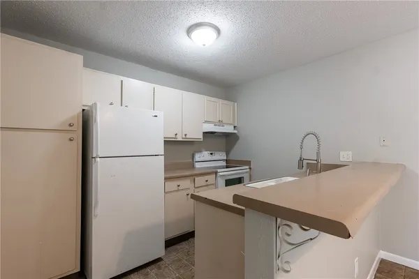 a white refrigerator freezer sitting inside of a kitchen