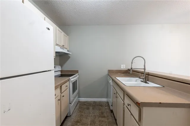a kitchen with a sink and a refrigerator