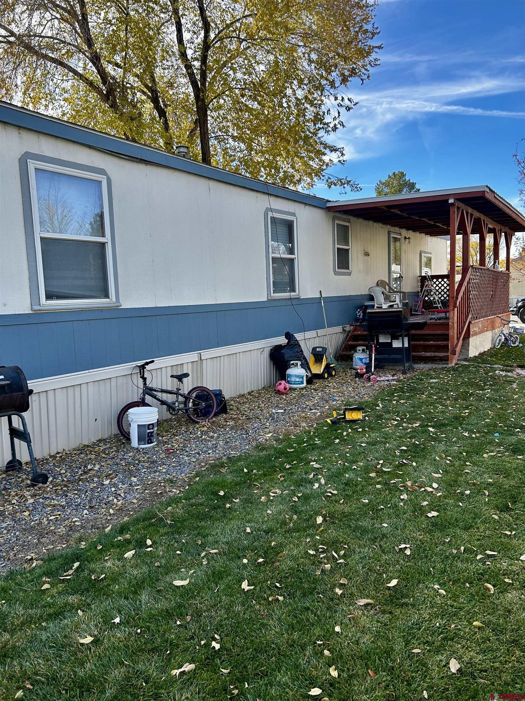 62880 Lasalle Road, Unit 129 Montrose, CO 81401 - Photo 4 of 4 a view of a house with backyard and sitting area