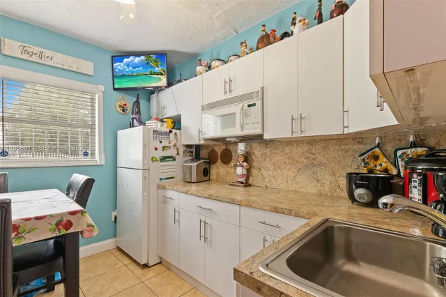 a kitchen with a sink cabinets and window