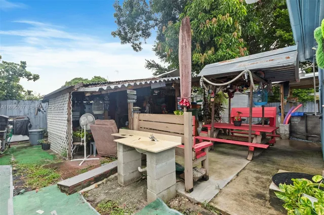 an outdoor sitting area with a table and chairs