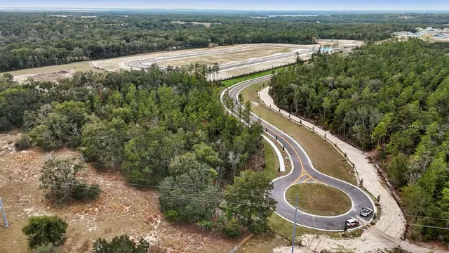 an aerial view of a house with yard swimming pool and outdoor seating