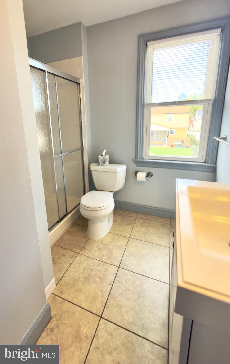 532 Lehigh Avenue, Unit 2 Swarthmore, PA 19081 - Photo 4 of 7 a bathroom with a toilet a sink and a shower