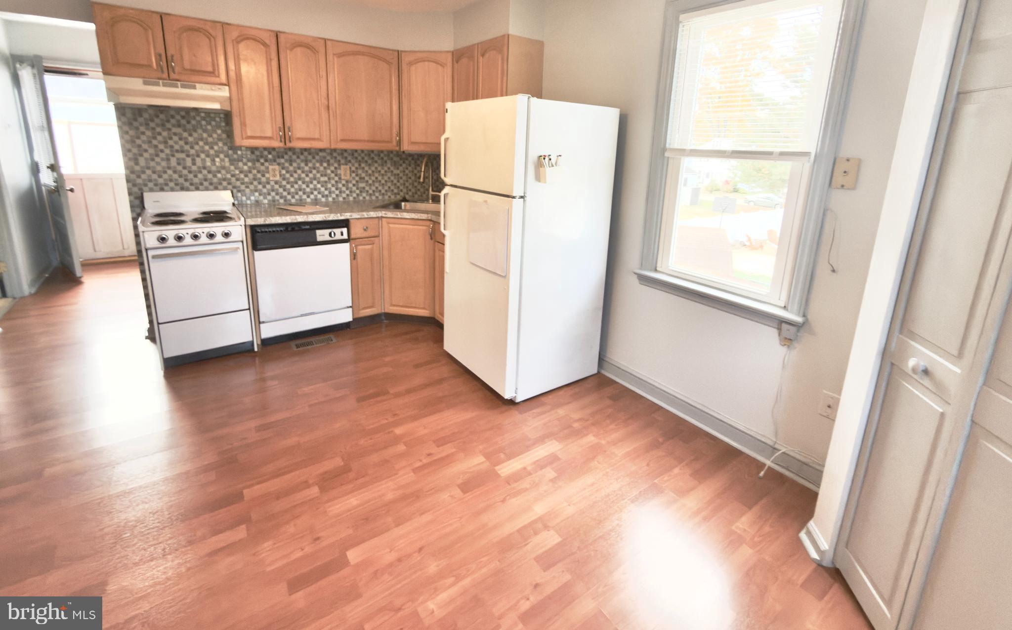 532 Lehigh Avenue, Unit 2 Swarthmore, PA 19081 - Photo 7 of 7 a kitchen with granite countertop a refrigerator and a stove