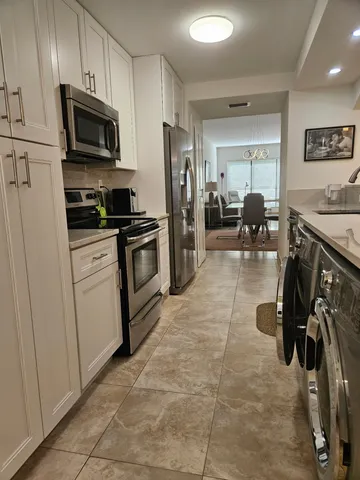 a kitchen with a sink stainless steel appliances and cabinets