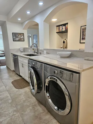a view of a sink and a washer dryer