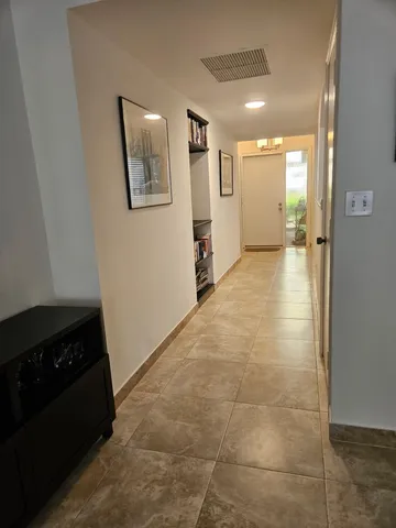 a view of an empty room and a bathroom