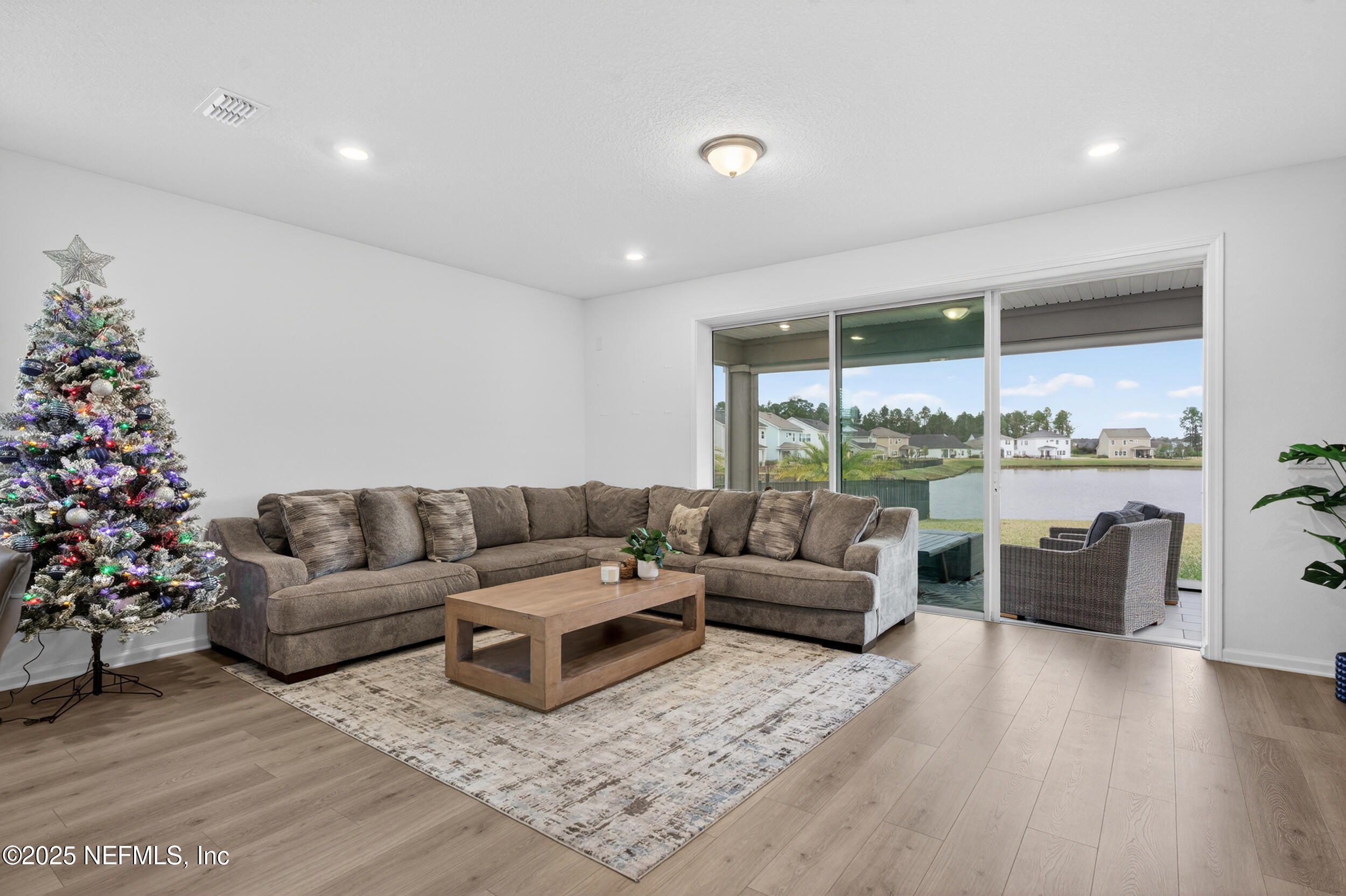 267 Twilight Lane St. Augustine, FL 32095 - Photo 15 of 50 a living room with furniture potted plant floor to ceiling window and a flat screen tv