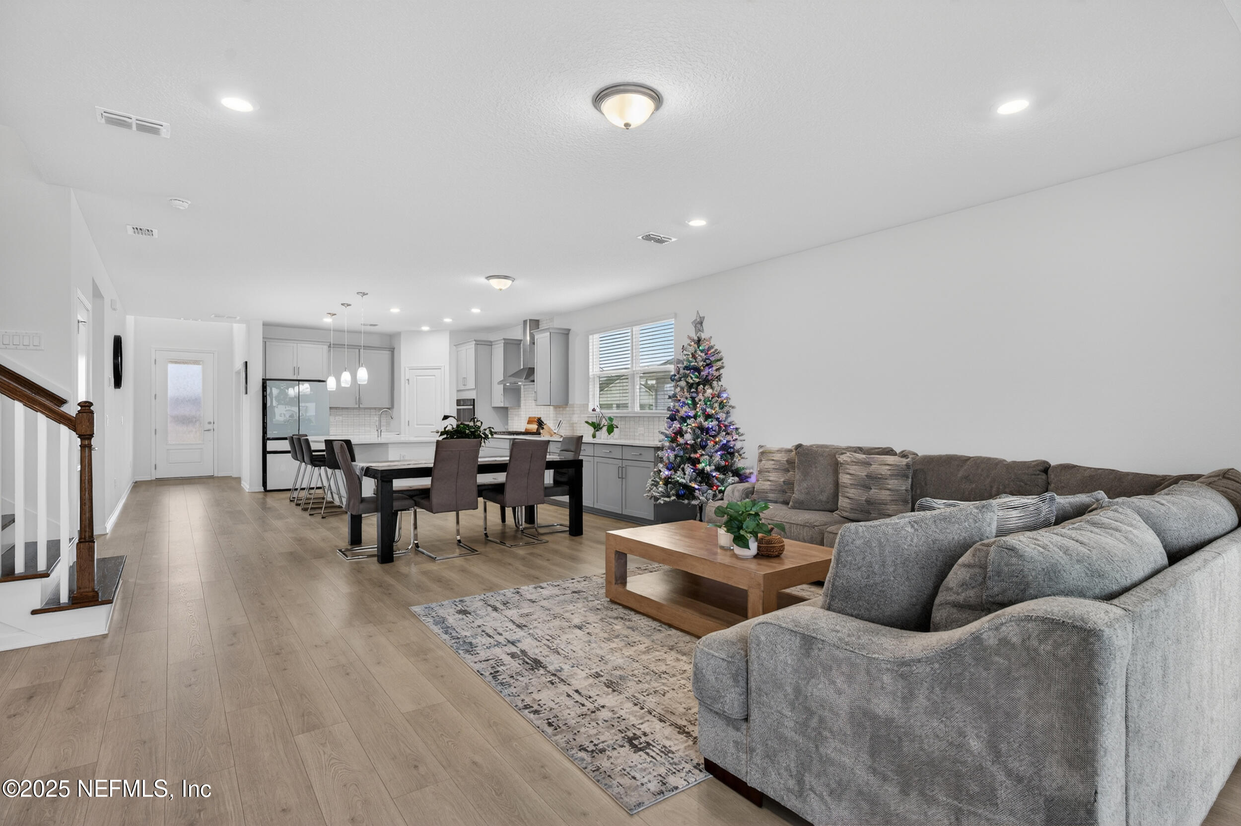 267 Twilight Lane St. Augustine, FL 32095 - Photo 17 of 50 a living room with furniture and a dining table with wooden floor