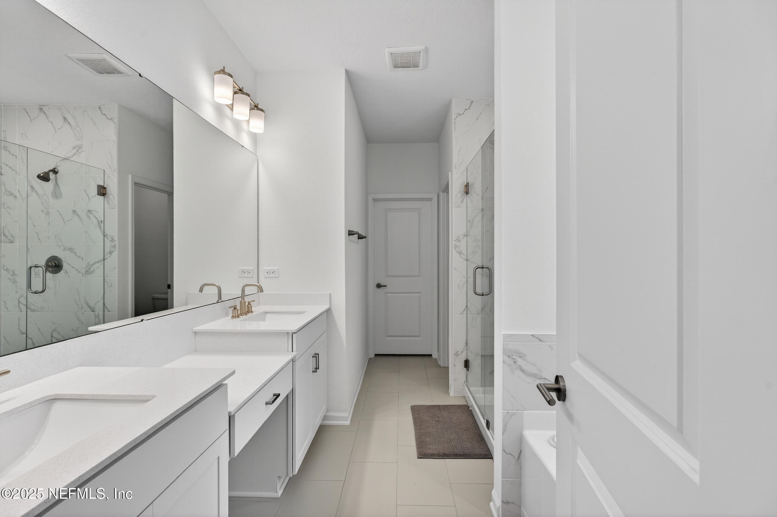 267 Twilight Lane St. Augustine, FL 32095 - Photo 23 of 50 a spacious bathroom with a double vanity sink a mirror and a bathtub