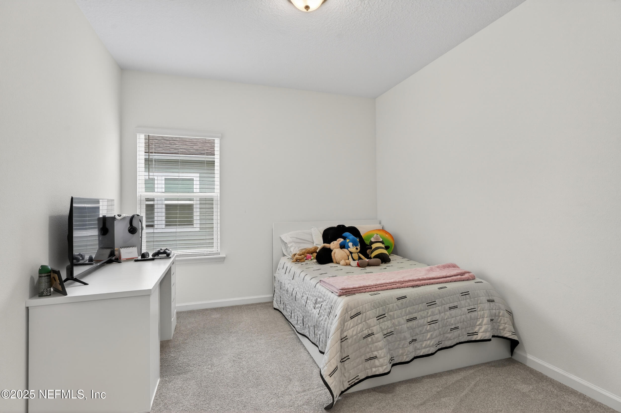 267 Twilight Lane St. Augustine, FL 32095 - Photo 29 of 50 a bedroom with a bed and a flat tv screen on the dresser