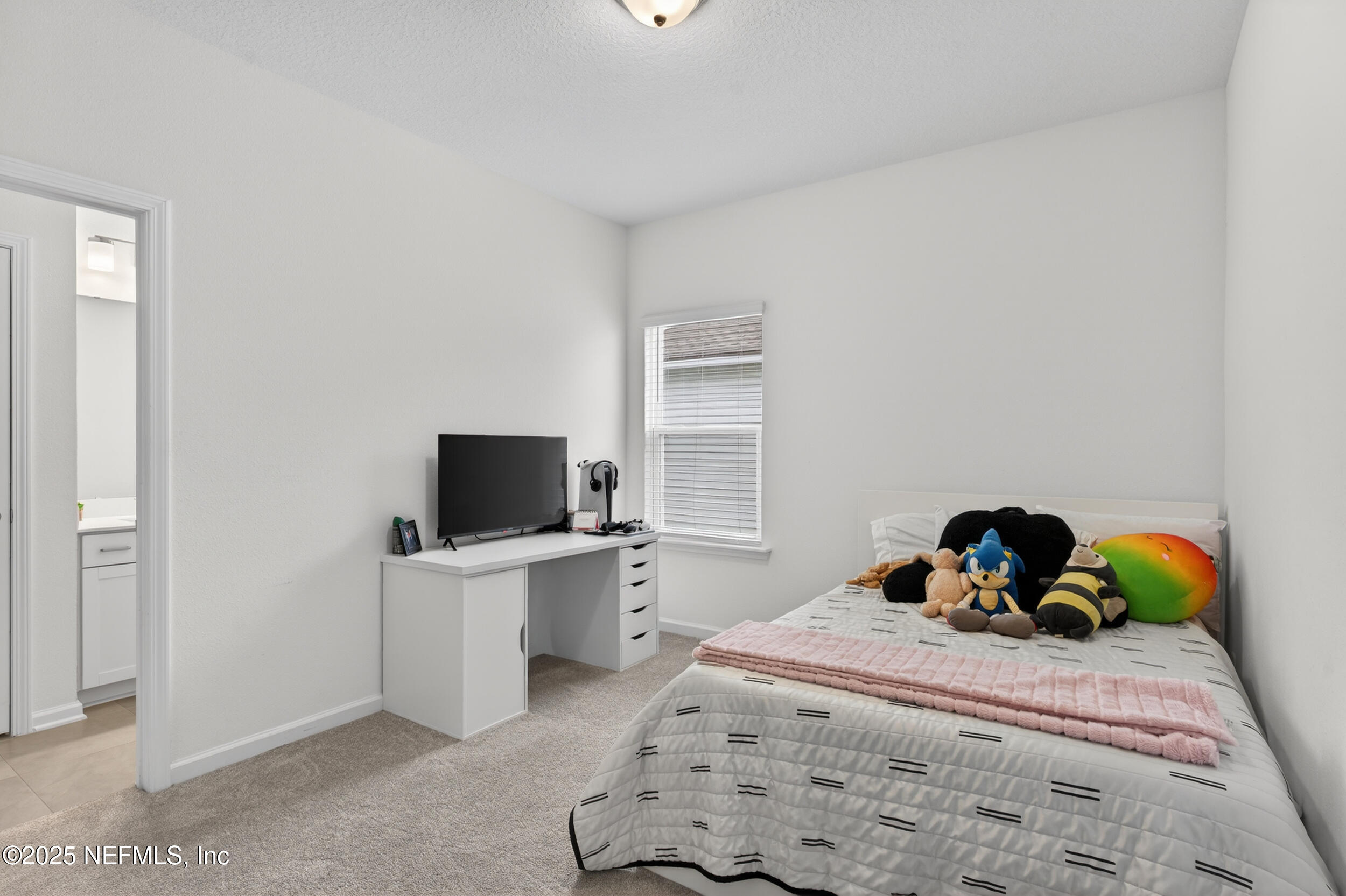 267 Twilight Lane St. Augustine, FL 32095 - Photo 30 of 50 a bedroom with a bed and a flat tv screen on dresser