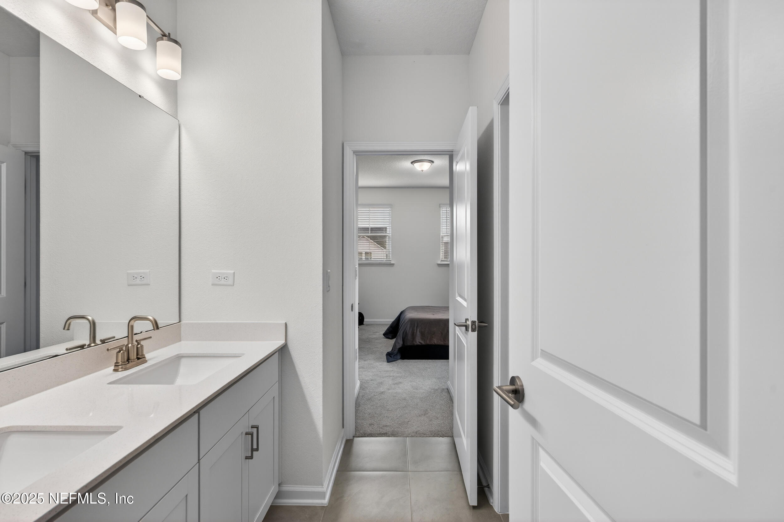 267 Twilight Lane St. Augustine, FL 32095 - Photo 35 of 50 a en suite bathroom with a sink a mirror and a shower