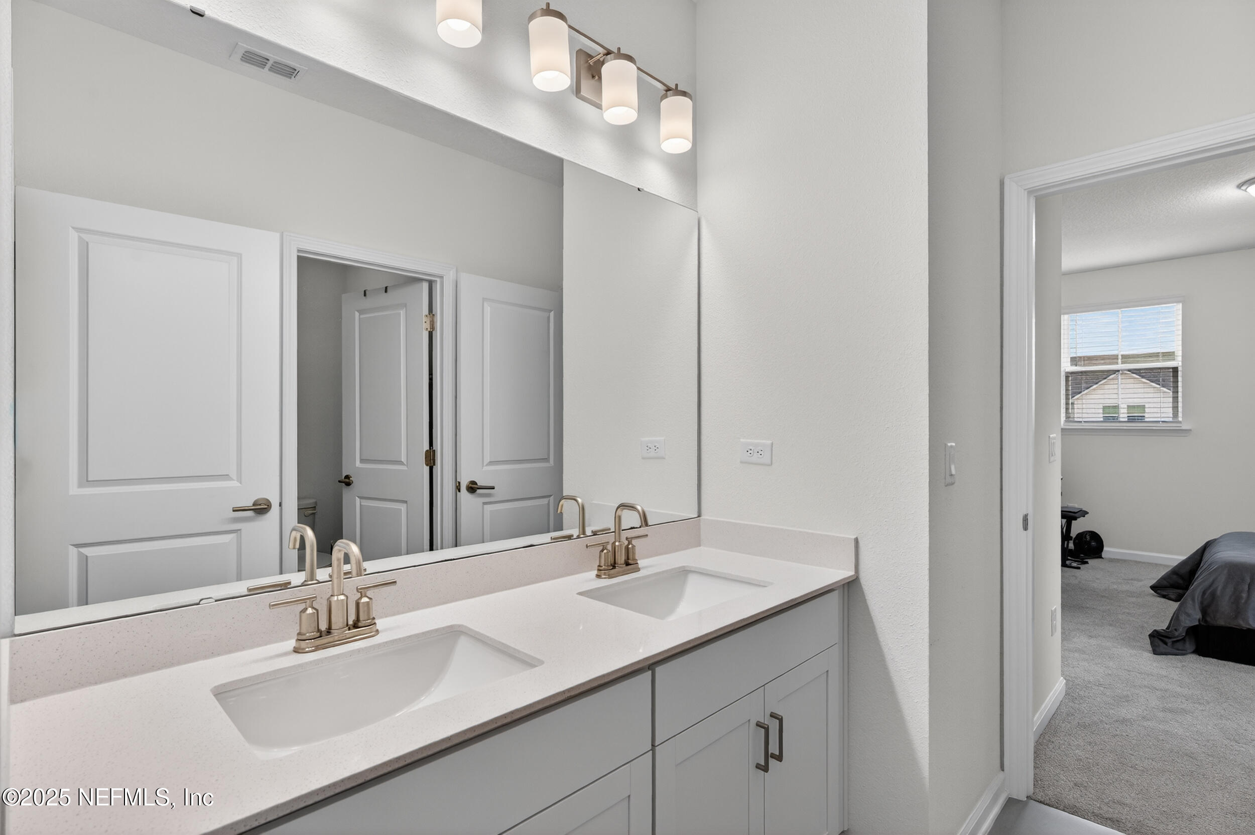 267 Twilight Lane St. Augustine, FL 32095 - Photo 36 of 50 a bathroom with a sink vanity and a mirror