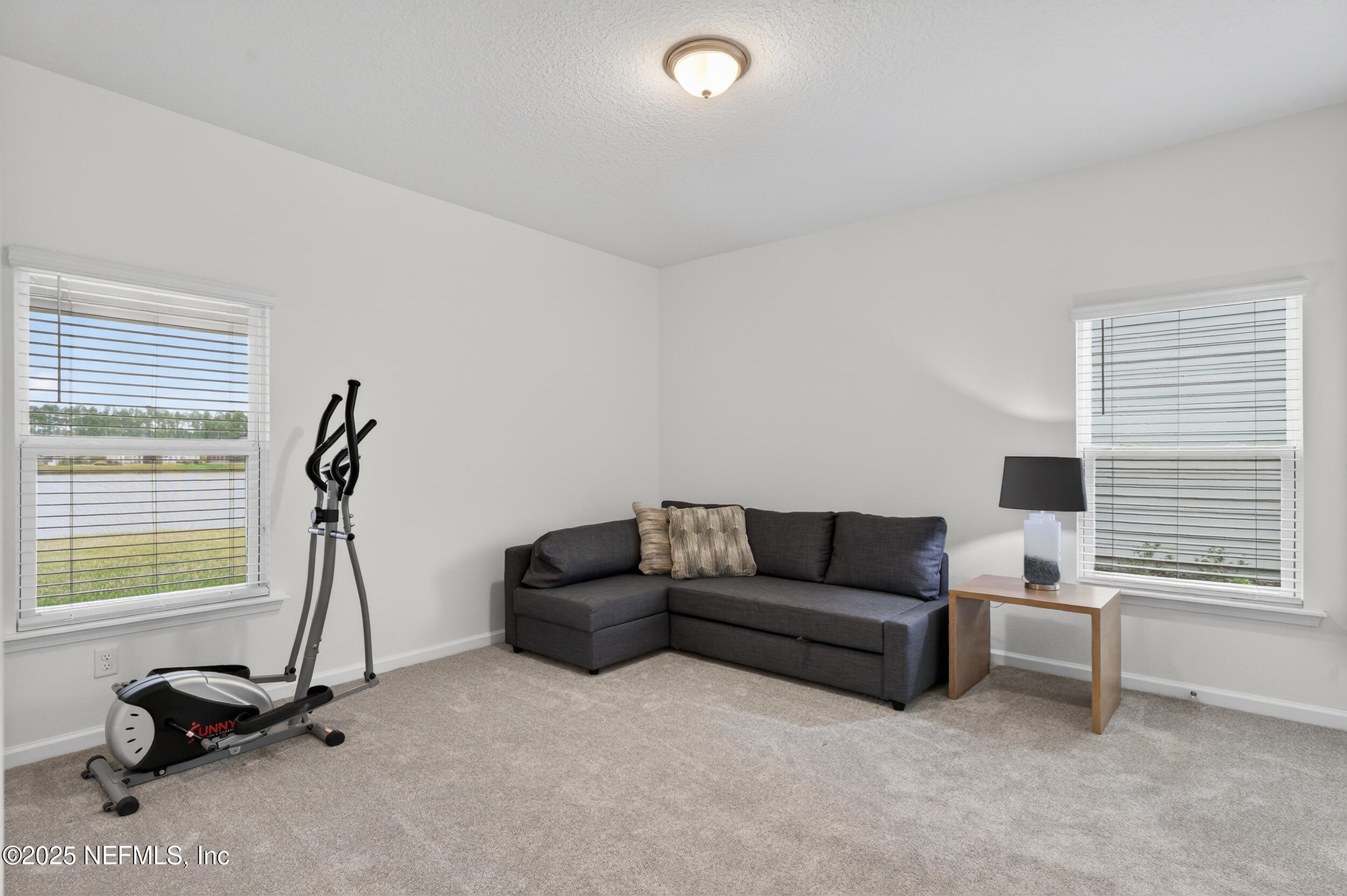 267 Twilight Lane St. Augustine, FL 32095 - Photo 40 of 50 a living room with furniture gym equipment and a window