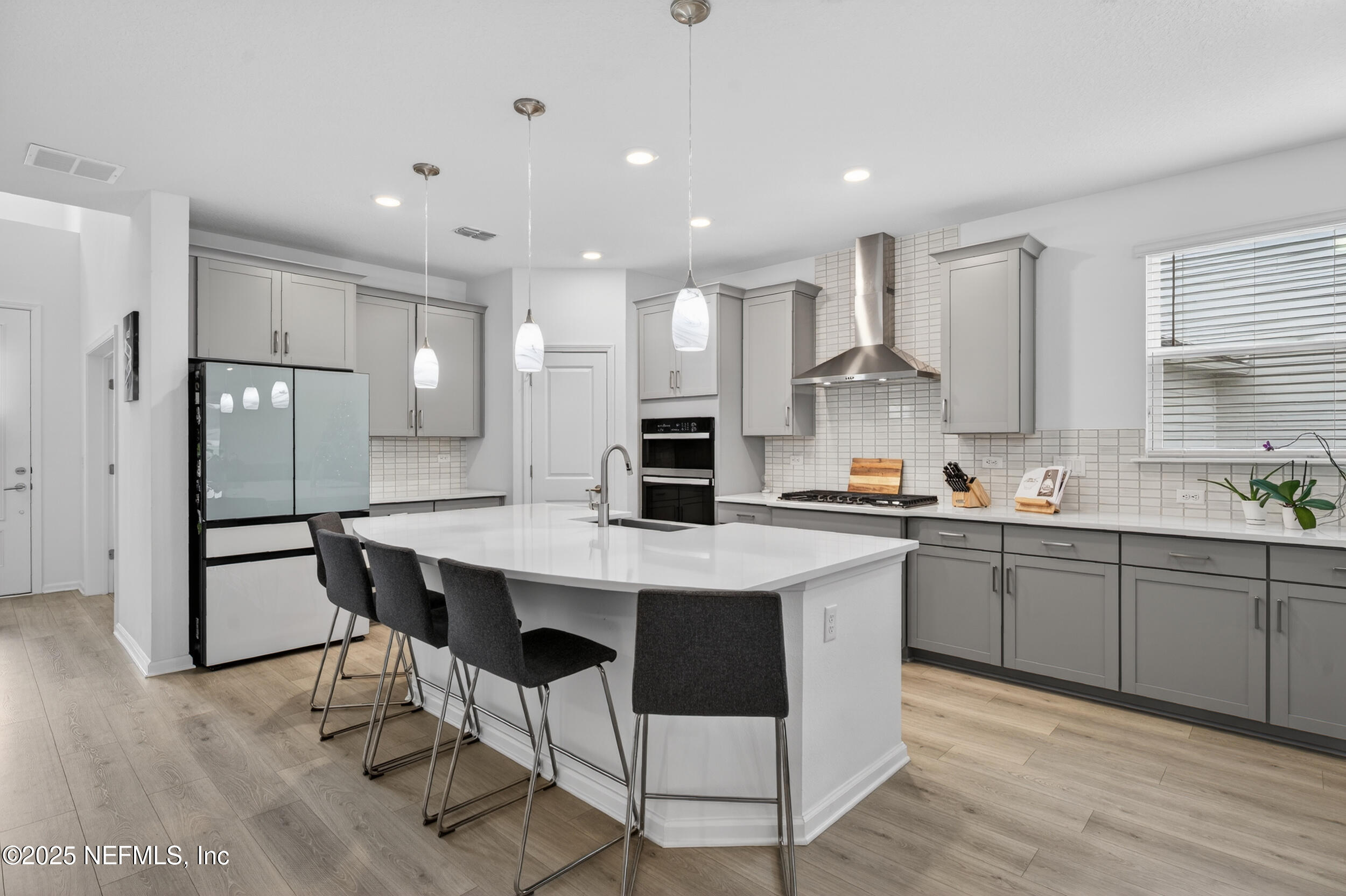 267 Twilight Lane St. Augustine, FL 32095 - Photo 8 of 50 a kitchen with stainless steel appliances granite countertop a table chairs sink refrigerator and cabinets
