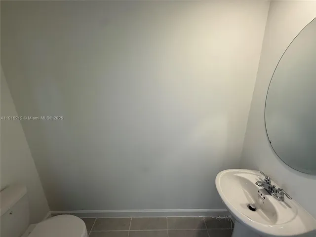 a bathroom with a sink mirror and toilet