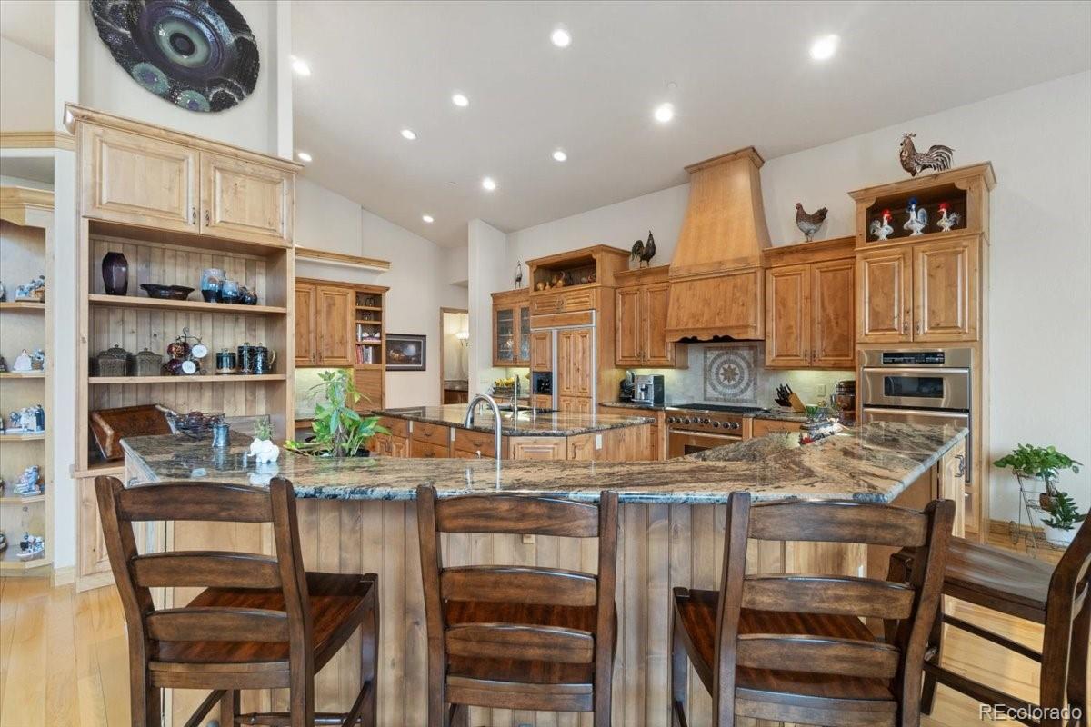 5881 Deer Meadow Trail Golden, CO 80403 - Photo 21 of 50 a kitchen with stainless steel appliances granite countertop a stove and a refrigerator