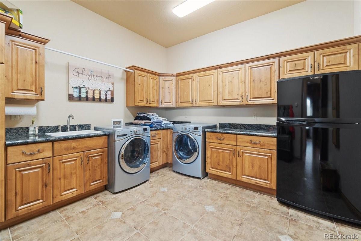 5881 Deer Meadow Trail Golden, CO 80403 - Photo 23 of 50 a utility room with stainless steel appliances granite countertop a refrigerator and a sink