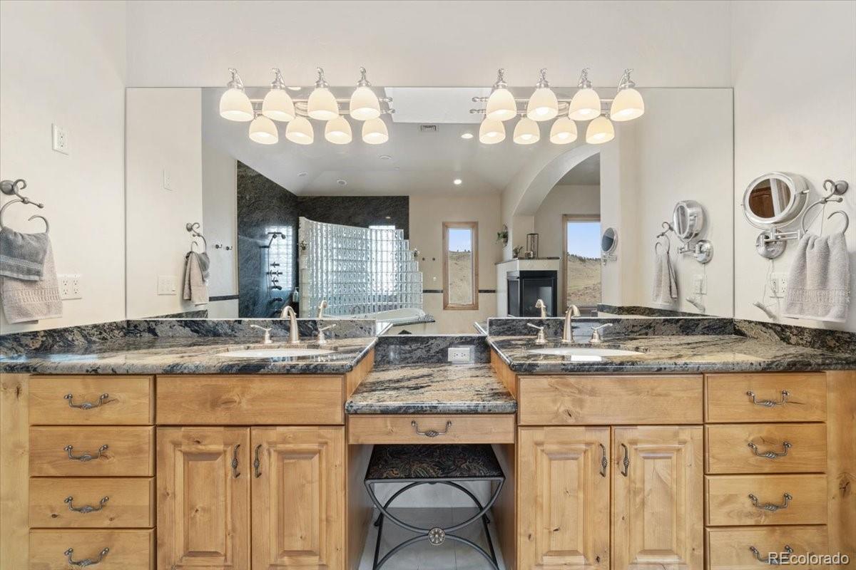 5881 Deer Meadow Trail Golden, CO 80403 - Photo 27 of 50 a kitchen with granite countertop a sink cabinets and stainless steel appliances