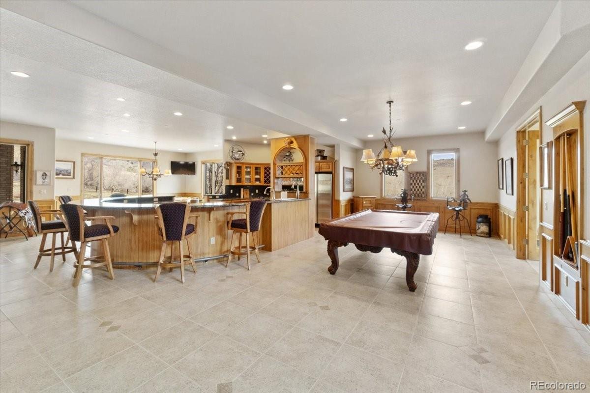 5881 Deer Meadow Trail Golden, CO 80403 - Photo 31 of 50 a living room with lots of furniture furniture and a kitchen view