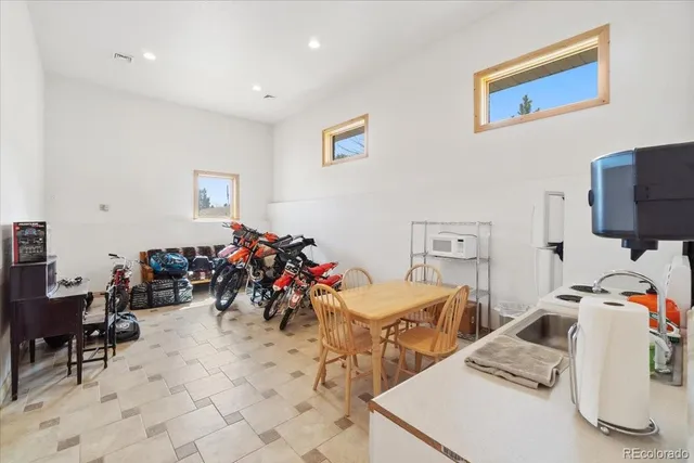 a kitchen with granite countertop cabinets sink and white appliances