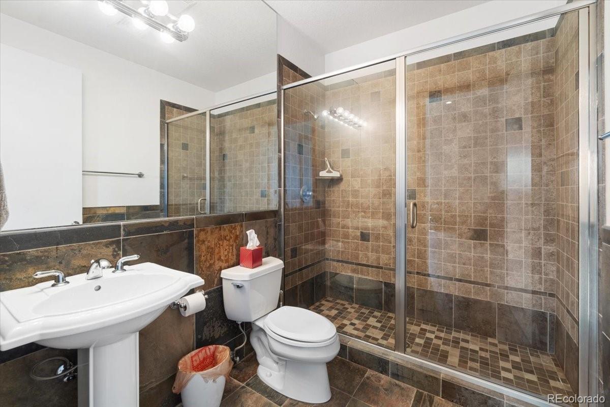 5881 Deer Meadow Trail Golden, CO 80403 - Photo 48 of 50 a bathroom with a sink toilet and shower