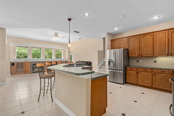 a kitchen with a sink a counter top space cabinets and stainless steel appliances