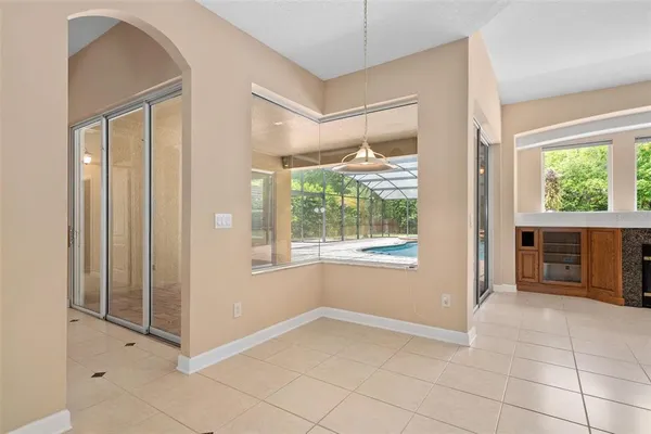 a living room with furniture and kitchen view