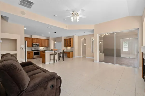 a view of an empty room with a window and a ceiling fan