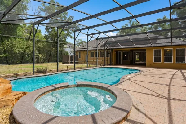 a view of a backyard with a swimming pool