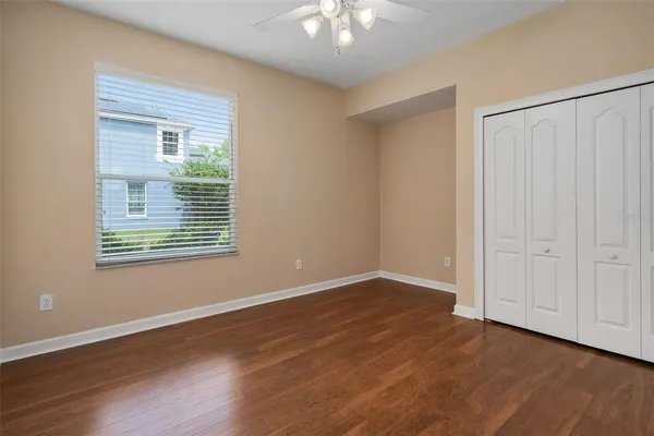 a view of an empty room with wooden floor