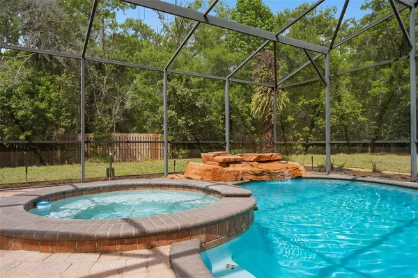 a view of a backyard with swimming pool