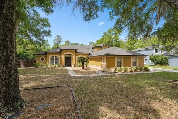 a front view of a house with yard porch and furniture