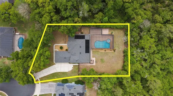 an aerial view of house with a yard