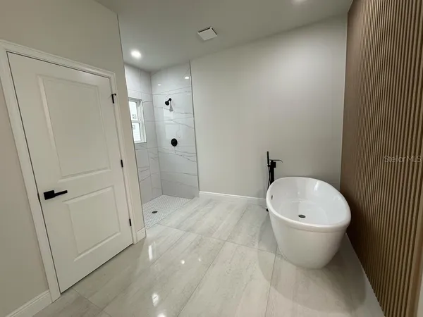 a spacious bathroom with a double vanity sink a mirror and a toilet