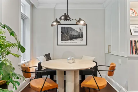 a view of a dining room with furniture and chandelier