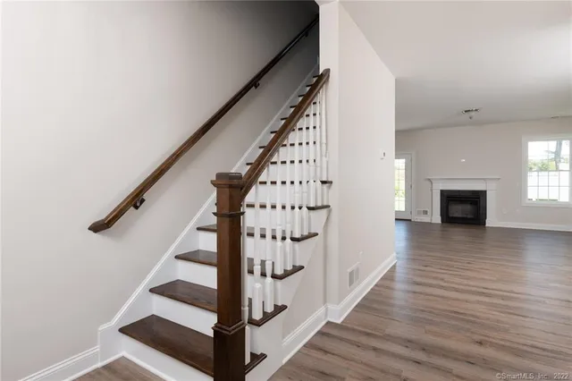 a view of entryway with wooden floor and staircase