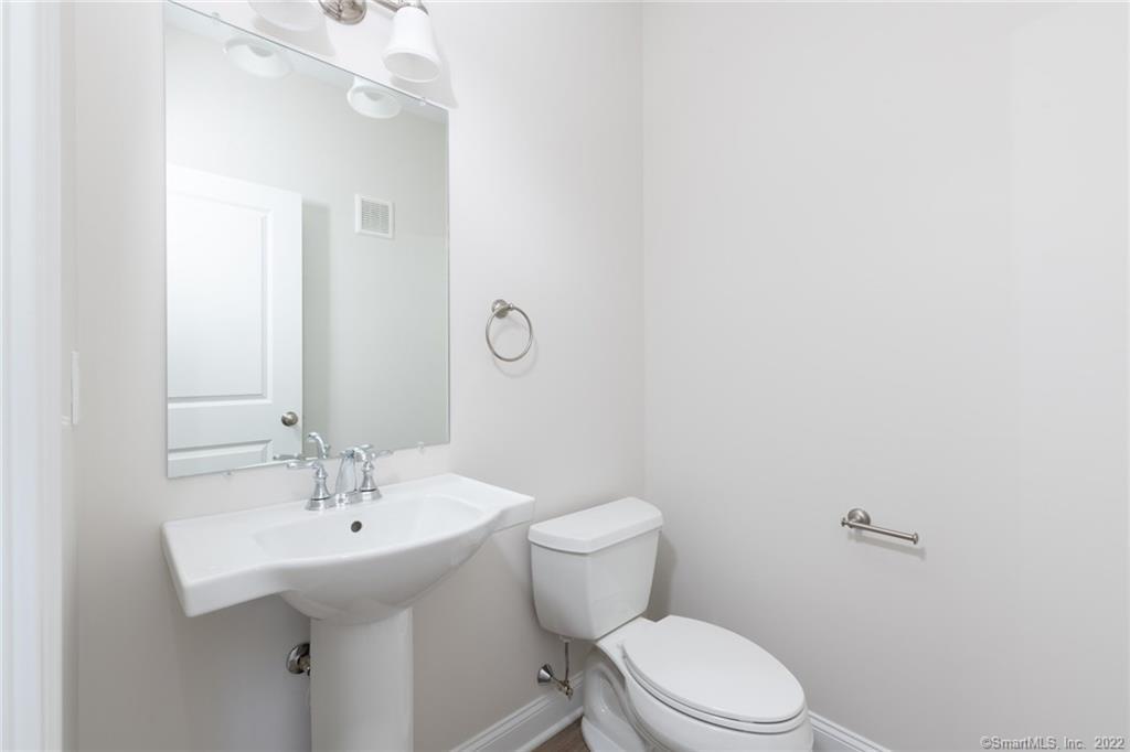 29 Covey Road, Unit 13 Burlington, CT 06013 - Photo 18 of 34 a bathroom with a sink a toilet and mirror