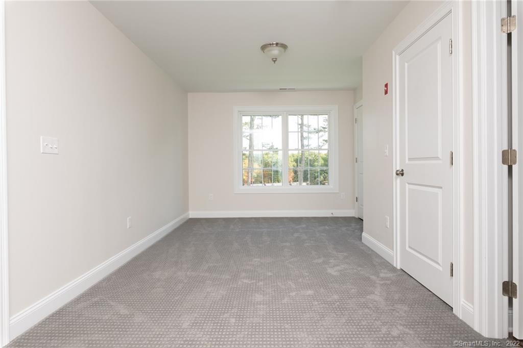29 Covey Road, Unit 13 Burlington, CT 06013 - Photo 21 of 34 an empty room with windows