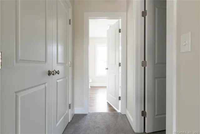 a view of a hallway with wooden floor