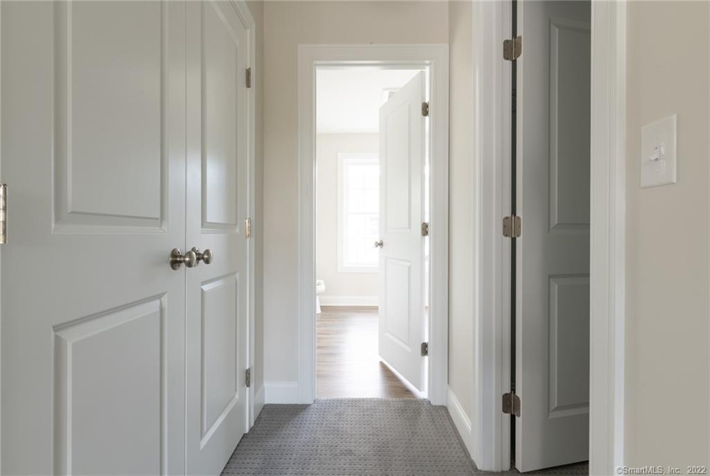 29 Covey Road, Unit 13 Burlington, CT 06013 - Photo 27 of 34 a view of a hallway with wooden floor