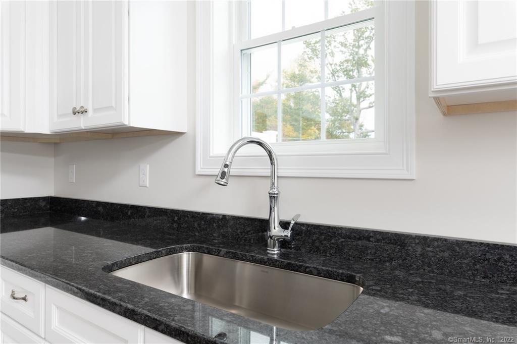 29 Covey Road, Unit 13 Burlington, CT 06013 - Photo 3 of 34 a kitchen with granite countertop a sink and a stove