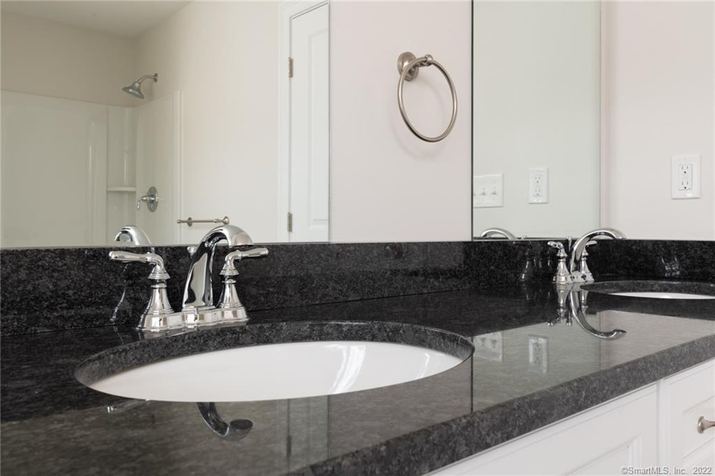 29 Covey Road, Unit 13 Burlington, CT 06013 - Photo 32 of 34 a bathroom with a granite countertop sink and a mirror